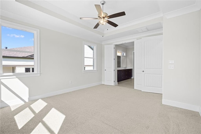 carpeted empty room with ceiling fan, a healthy amount of sunlight, and crown molding