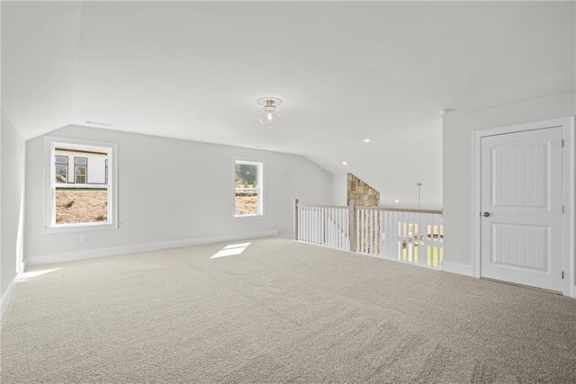 additional living space with carpet and vaulted ceiling