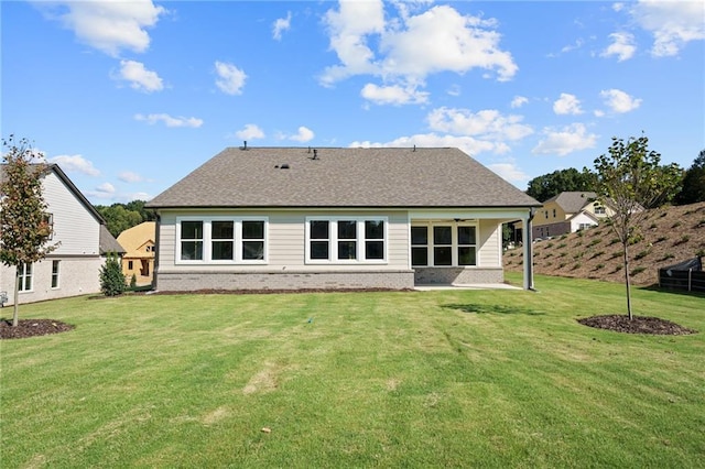 rear view of house with a lawn