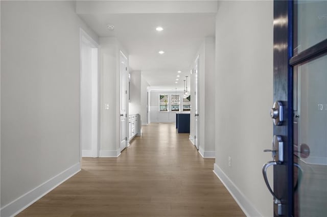 corridor with hardwood / wood-style floors