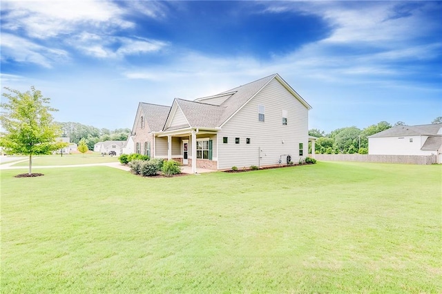 rear view of property with a yard