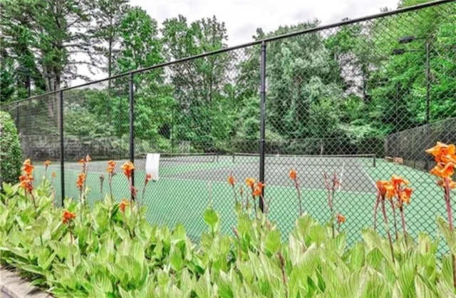 view of tennis court with fence