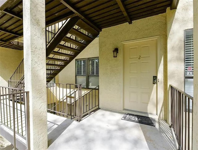 view of exterior entry with stucco siding
