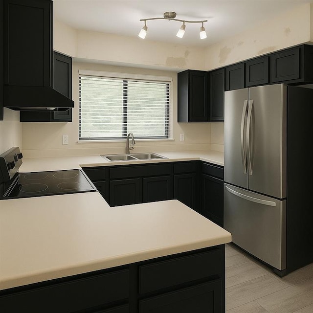 kitchen with a sink, electric range oven, light countertops, extractor fan, and freestanding refrigerator