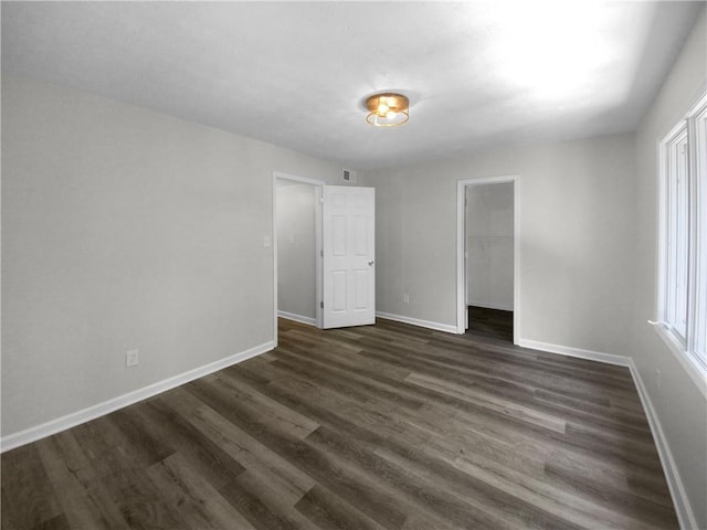 empty room featuring dark wood-type flooring