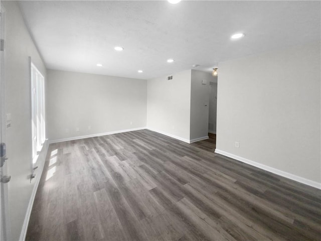 spare room featuring dark wood-type flooring