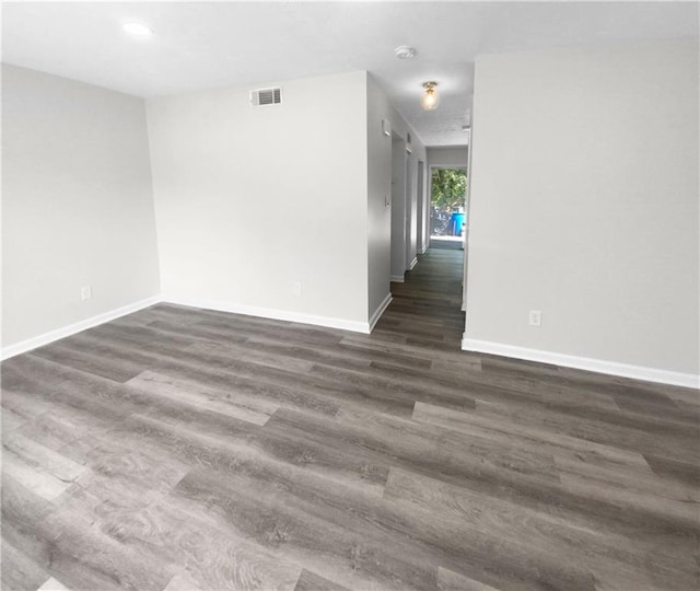 spare room featuring dark hardwood / wood-style flooring