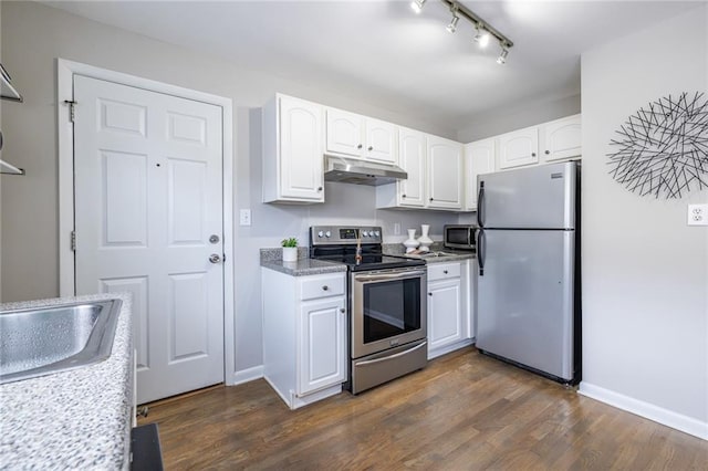 kitchen featuring appliances with stainless steel finishes, white cabinetry, rail lighting, sink, and dark hardwood / wood-style flooring