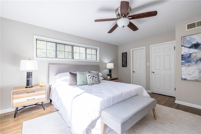 bedroom with ceiling fan and hardwood / wood-style floors