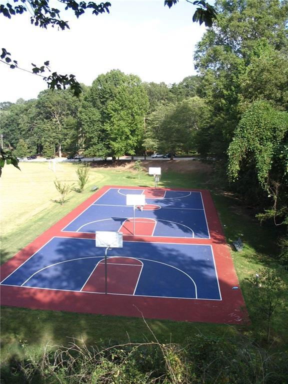 view of basketball court featuring a yard