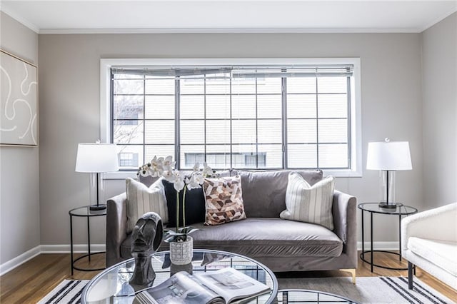 living room featuring hardwood / wood-style flooring, ornamental molding, and a healthy amount of sunlight