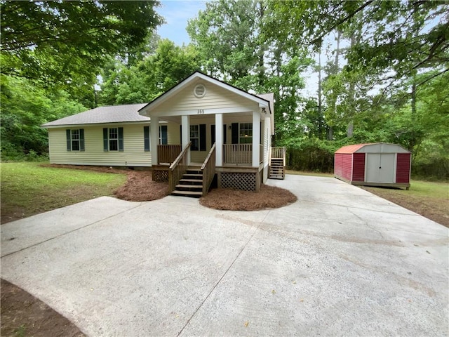 355 Marietta Hwy, Roswell, GA 30075 - view of front of home with covered porch, concrete driveway, and view of scattered trees