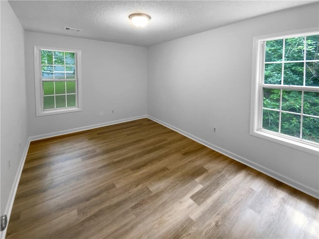 355 Marietta Hwy, Roswell, GA 30075 - empty room featuring baseboards, wood finished floors, and a textured ceiling