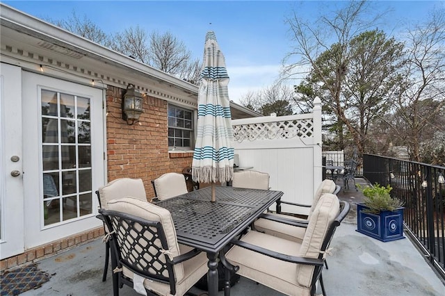 view of patio with outdoor dining area and fence