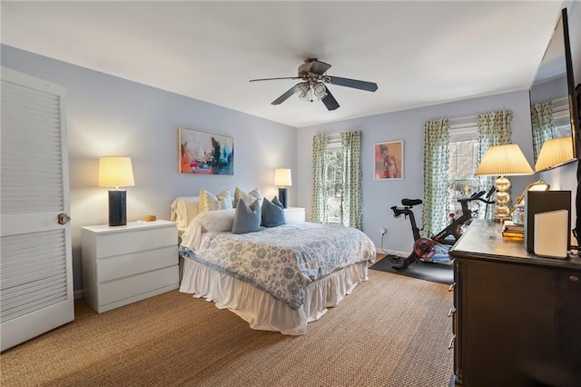 bedroom with ceiling fan, carpet, and baseboards