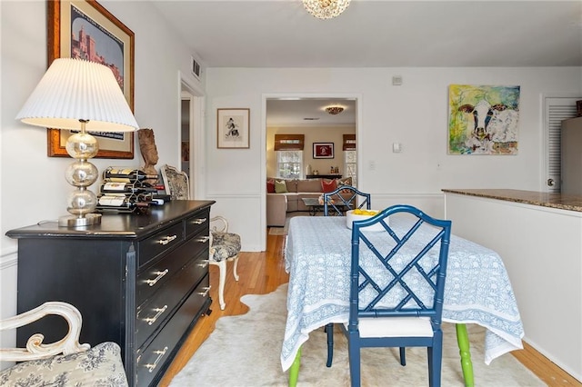 dining area featuring visible vents and light wood finished floors