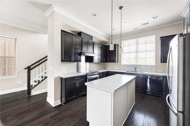 164 Blakemore Dr, Smyrna, GA 30080 - kitchen featuring appliances with stainless steel finishes, dark wood finished floors, under cabinet range hood, a center island, and pendant lighting
