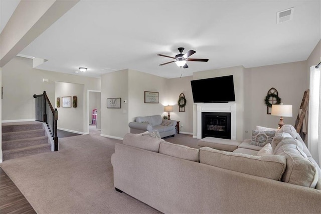 7 Wilmer Way, Cartersville, GA 30120 - carpeted living room with stairway, a glass covered fireplace, and a ceiling fan
