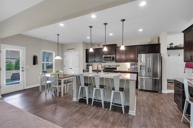 7 Wilmer Way, Cartersville, GA 30120 - kitchen with stainless steel appliances, dark wood finished floors, dark brown cabinets, light stone countertops, and recessed lighting