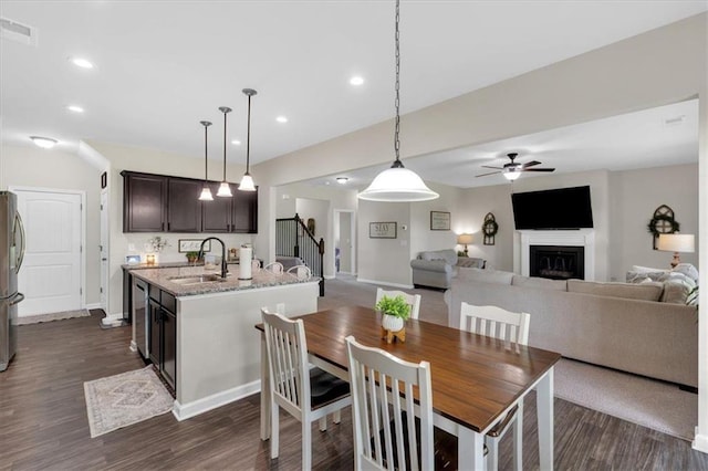 7 Wilmer Way, Cartersville, GA 30120 - dining space featuring a fireplace, dark wood-type flooring, ceiling fan, stairs, and recessed lighting