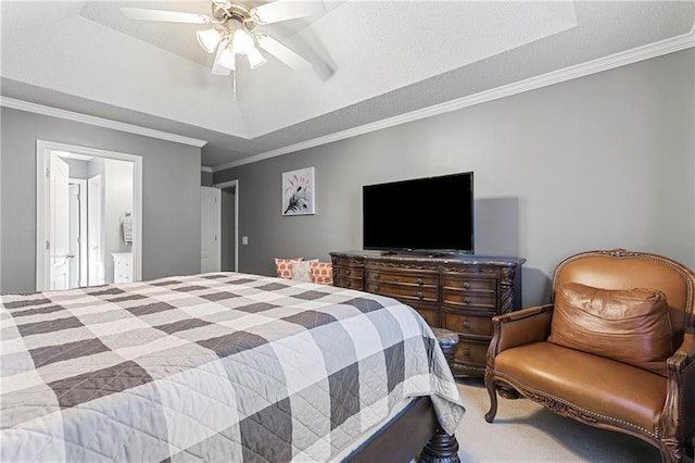 carpeted bedroom with ceiling fan, ornamental molding, a raised ceiling, and connected bathroom