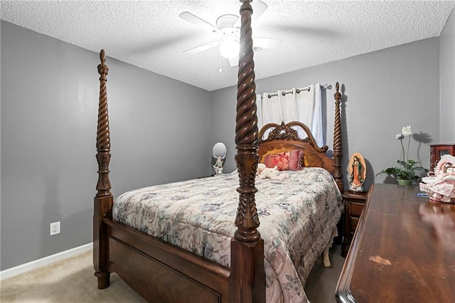 carpeted bedroom featuring a ceiling fan, baseboards, and a textured ceiling