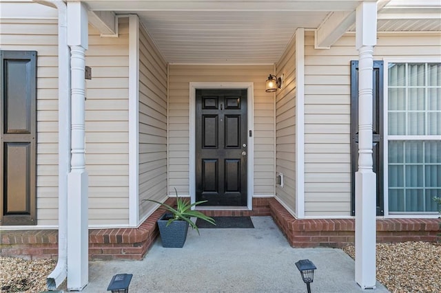 view of exterior entry with covered porch