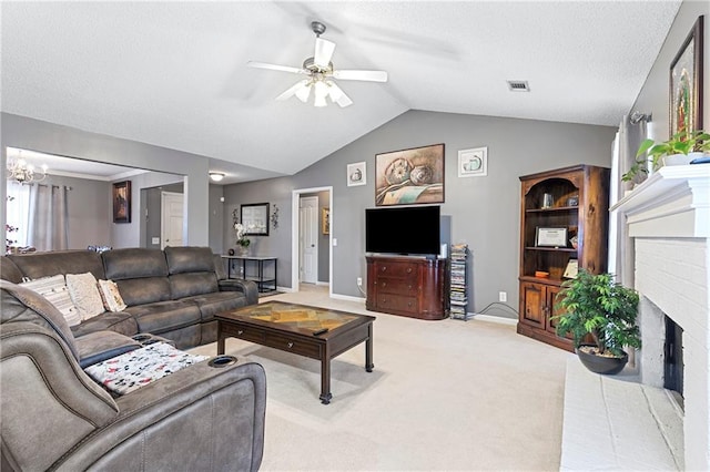 living area featuring a fireplace, lofted ceiling, light colored carpet, visible vents, and ceiling fan with notable chandelier