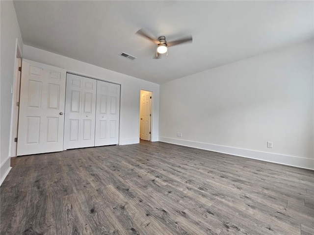 unfurnished bedroom featuring a closet, wood-type flooring, and ceiling fan