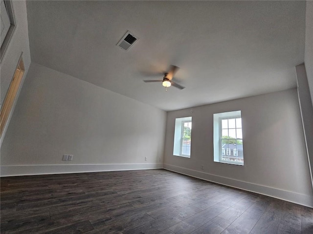 spare room with ceiling fan and dark wood-type flooring