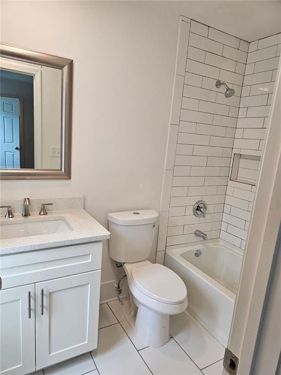 full bathroom featuring tile patterned flooring, tiled shower / bath combo, toilet, and vanity