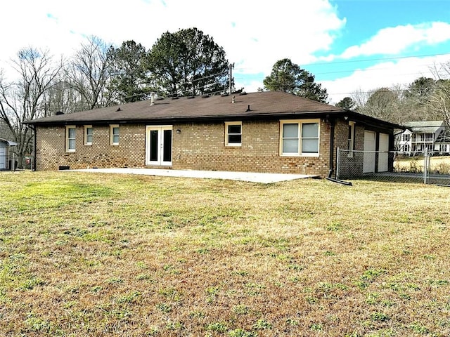 back of property featuring french doors, a yard, and a patio