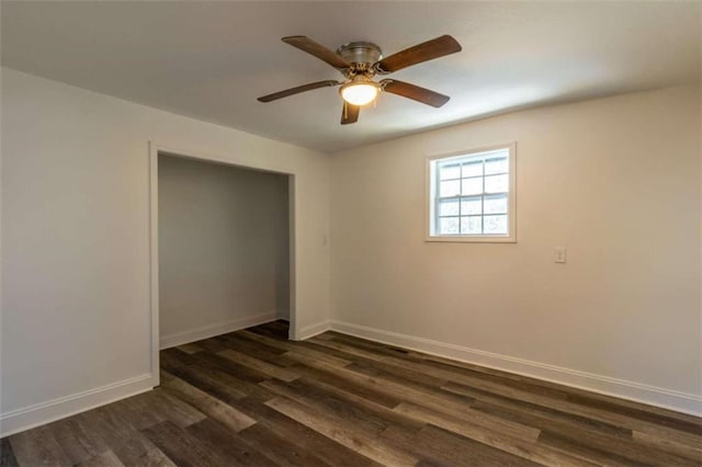 unfurnished bedroom with dark wood-style floors, ceiling fan, and baseboards