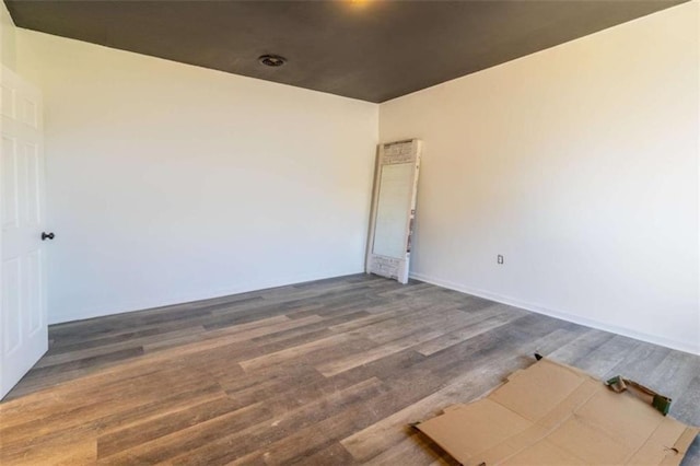 unfurnished room with wood finished floors