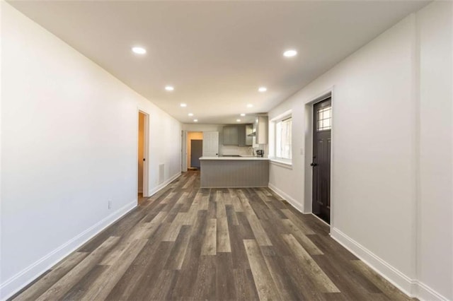 interior space featuring recessed lighting, dark wood finished floors, and baseboards