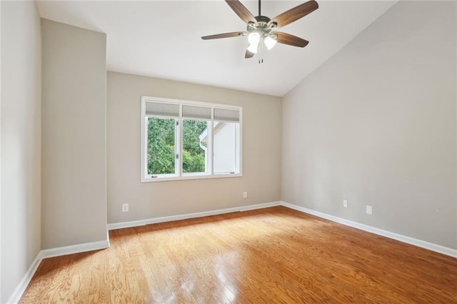 spare room featuring ceiling fan, light hardwood / wood-style flooring, and lofted ceiling