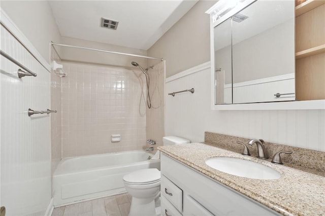 full bathroom featuring vanity, toilet, and tiled shower / bath