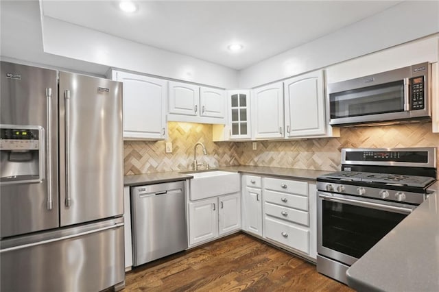 kitchen featuring white cabinets, dark hardwood / wood-style flooring, stainless steel appliances, and sink