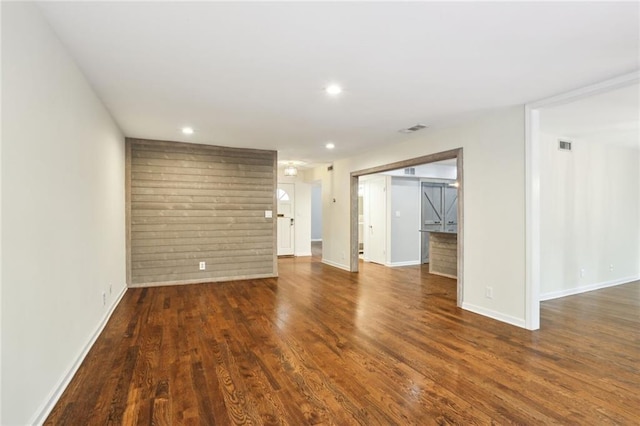 unfurnished room featuring dark wood-type flooring