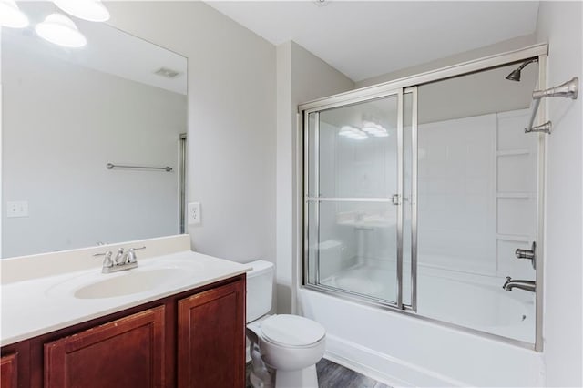 full bathroom with toilet, enclosed tub / shower combo, and vanity