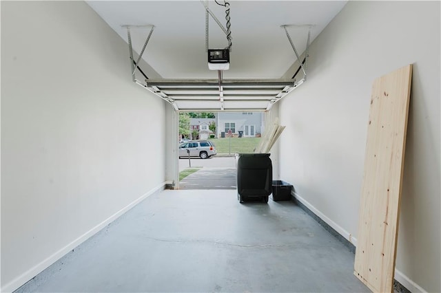 garage featuring a garage door opener and baseboards
