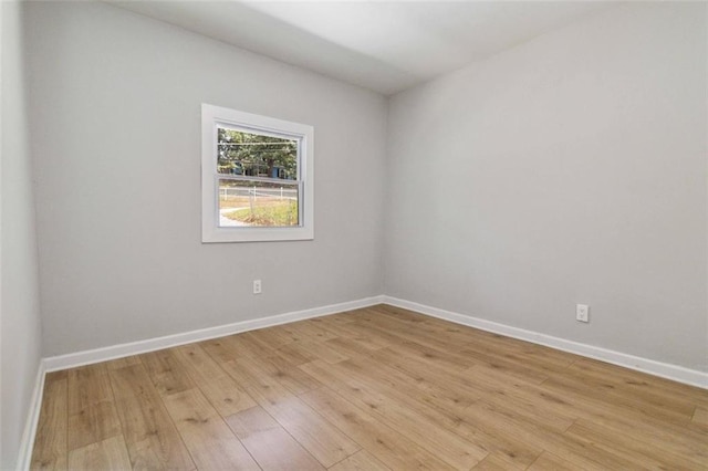 spare room with light wood finished floors and baseboards