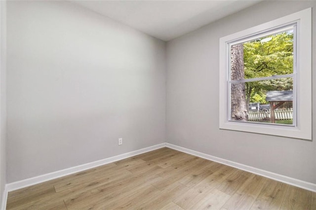 unfurnished room with light wood-style floors and baseboards