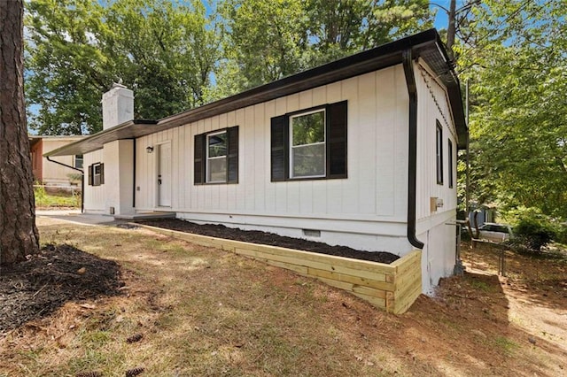 view of front of property featuring crawl space and a chimney