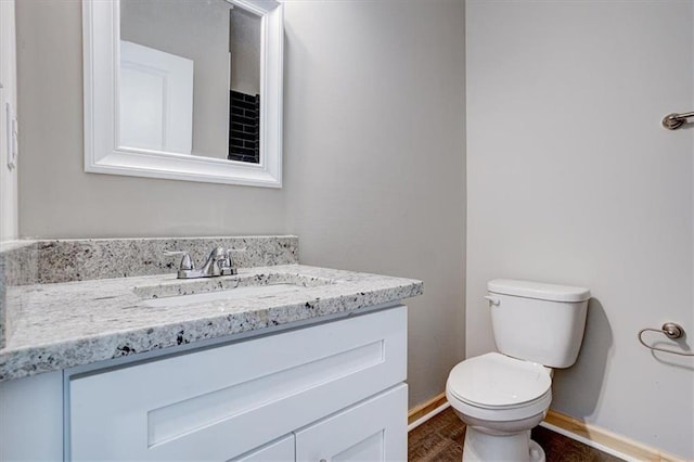 bathroom featuring vanity and toilet