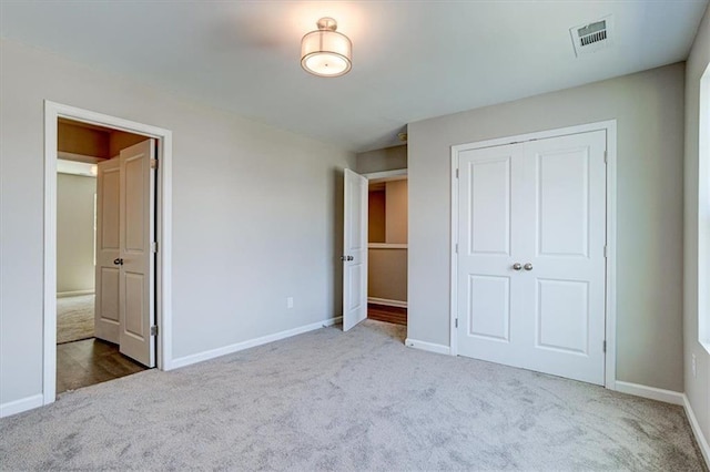 unfurnished bedroom featuring a closet and carpet