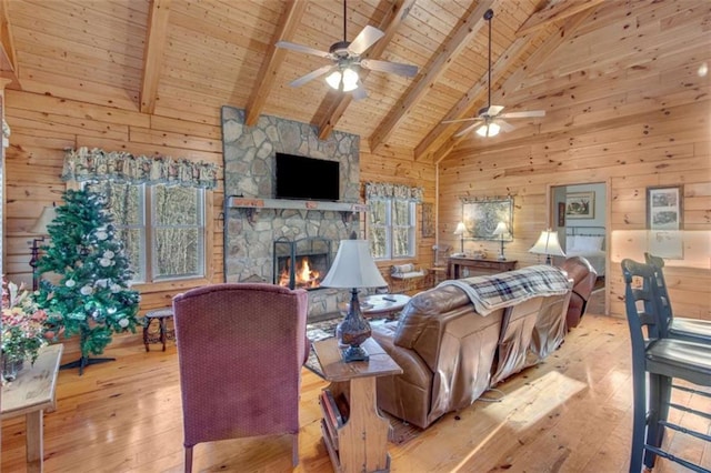 living room with wooden ceiling, high vaulted ceiling, light wood-type flooring, a fireplace, and beam ceiling