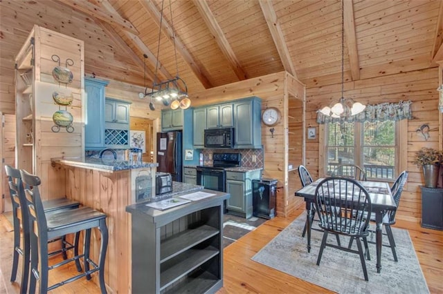 kitchen with wooden ceiling, black appliances, light hardwood / wood-style floors, beam ceiling, and kitchen peninsula