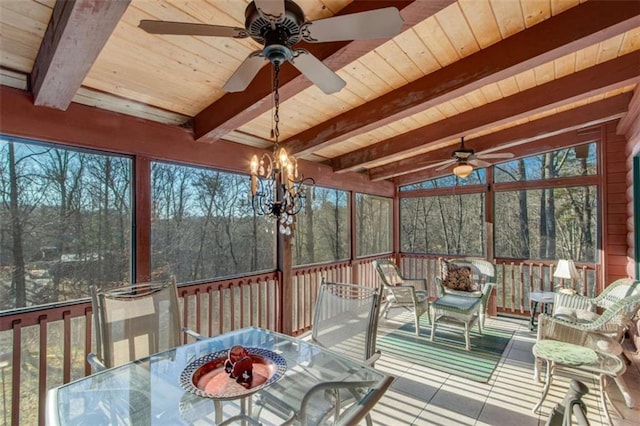 unfurnished sunroom featuring a wealth of natural light and ceiling fan with notable chandelier