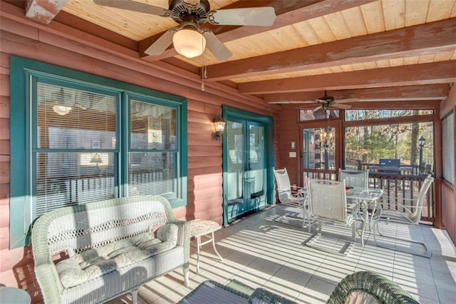 sunroom / solarium with beamed ceiling, ceiling fan, and wood ceiling